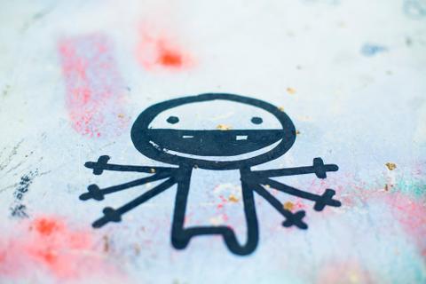 Childlike sketch of a smiling figure with six arms.