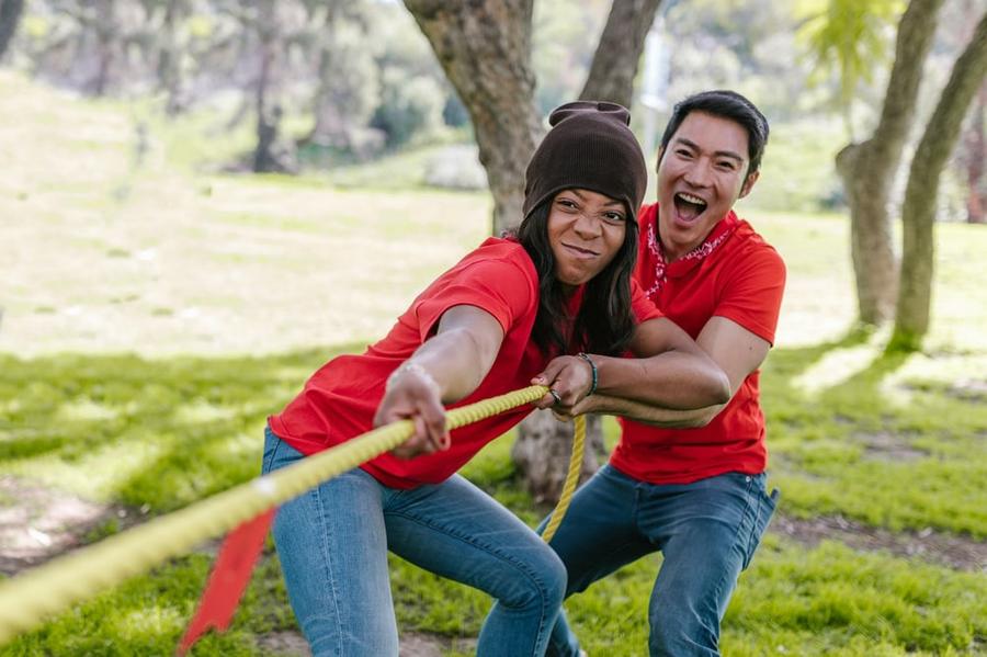 Two people play tug of war.