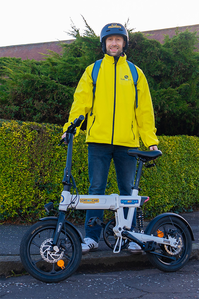 A SortMyCar driver with his e-bike