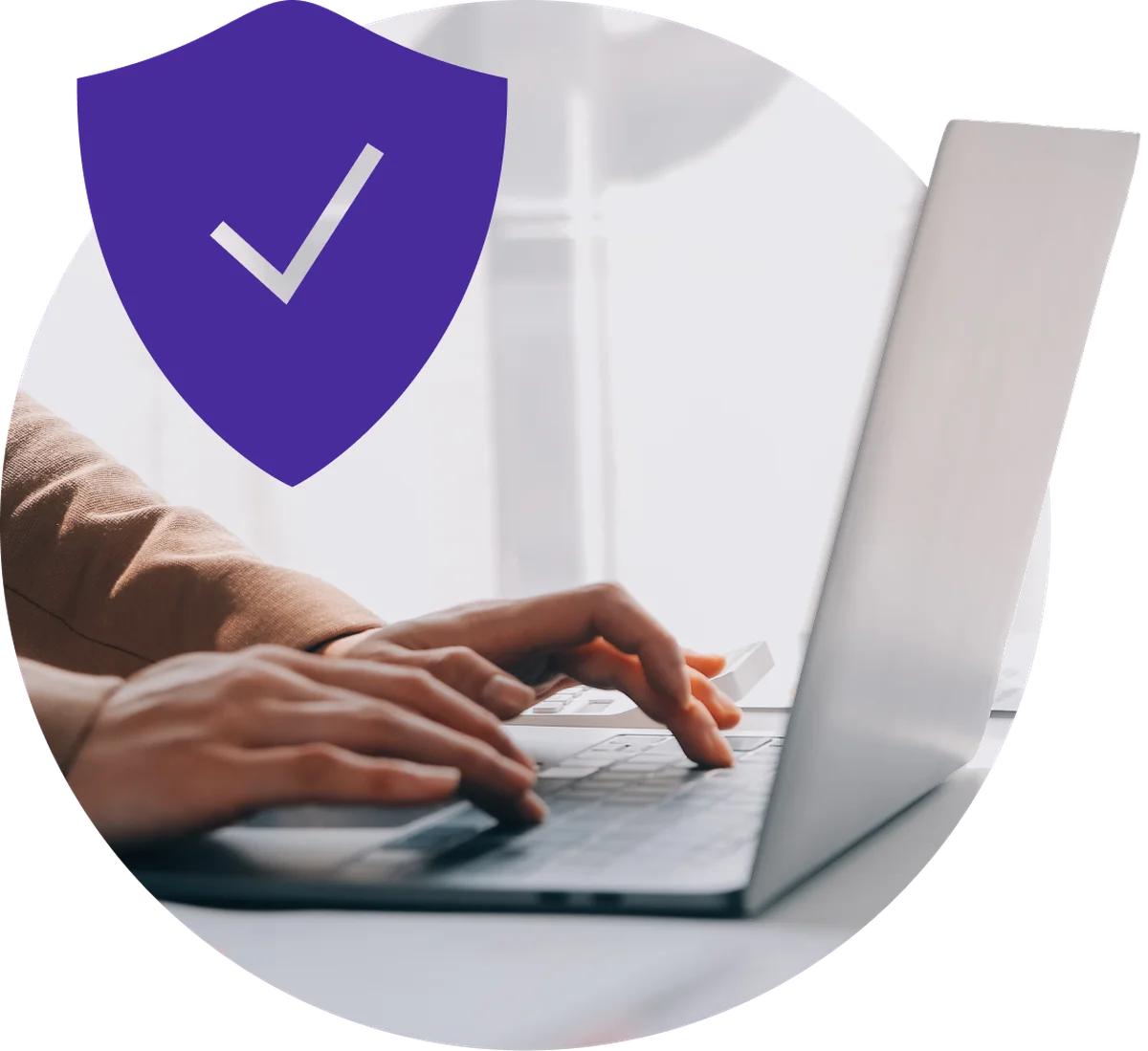A shield with a tick, over someone working at a laptop