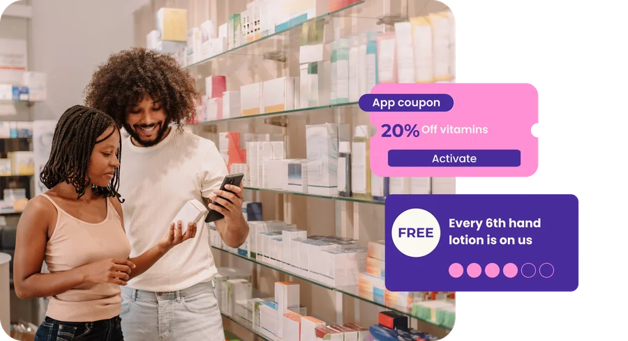 Shoppers in a pharmacy aisle with an app coupon for 20% off vitamins and a stamp card reading 'every 6th hand lotion is on us'