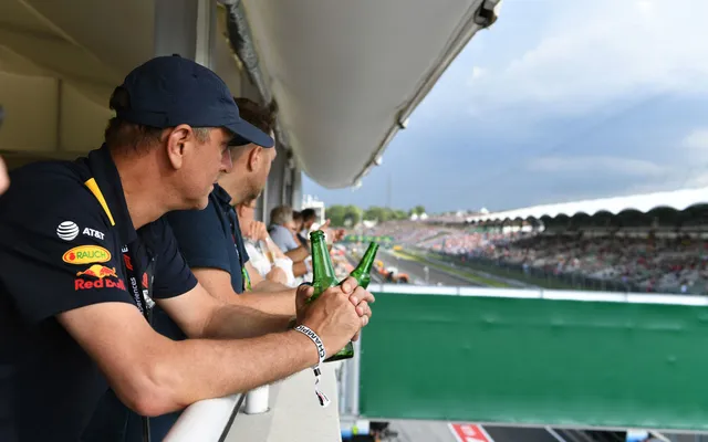 A guest on a hospitality balcony above the pit lane.