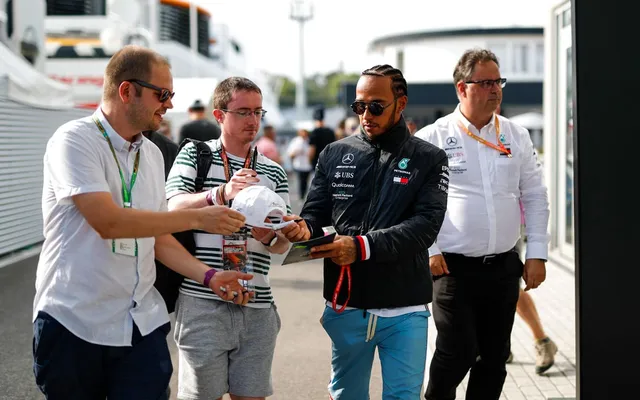 Lewis Hamilton with guests in the paddock.