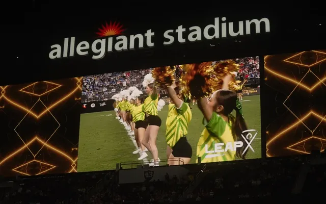 Dancers up on the giant screen at Allegiant Stadium