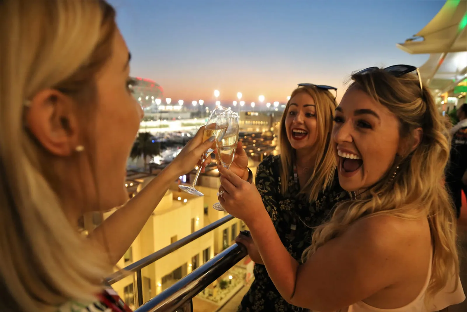 Guests toasting in hospitality as the floodlights come on.
