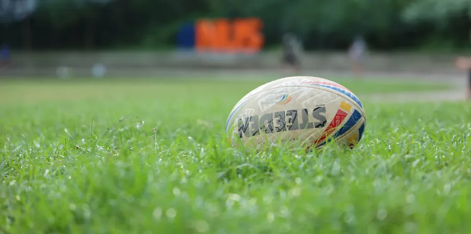 A rugby league ball on the grass.