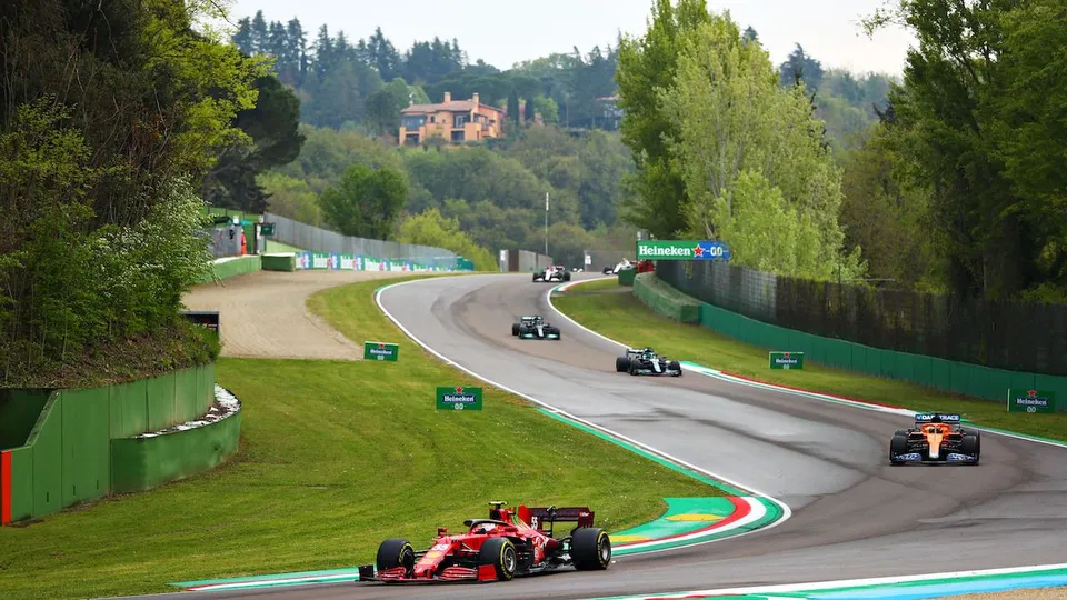 Cars sweeping through the Parabolica at Monza.