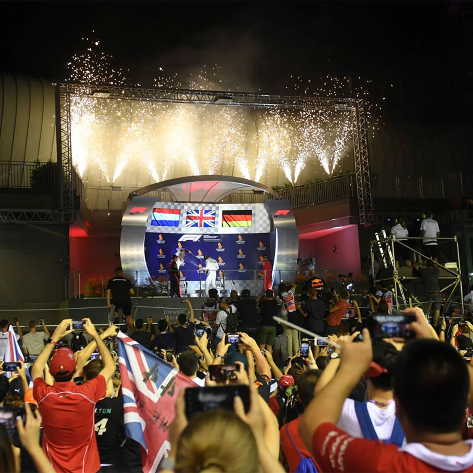 The podium under the lights, fireworks overhead.