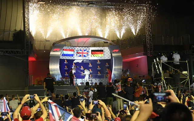 The podium under the lights, fireworks overhead.