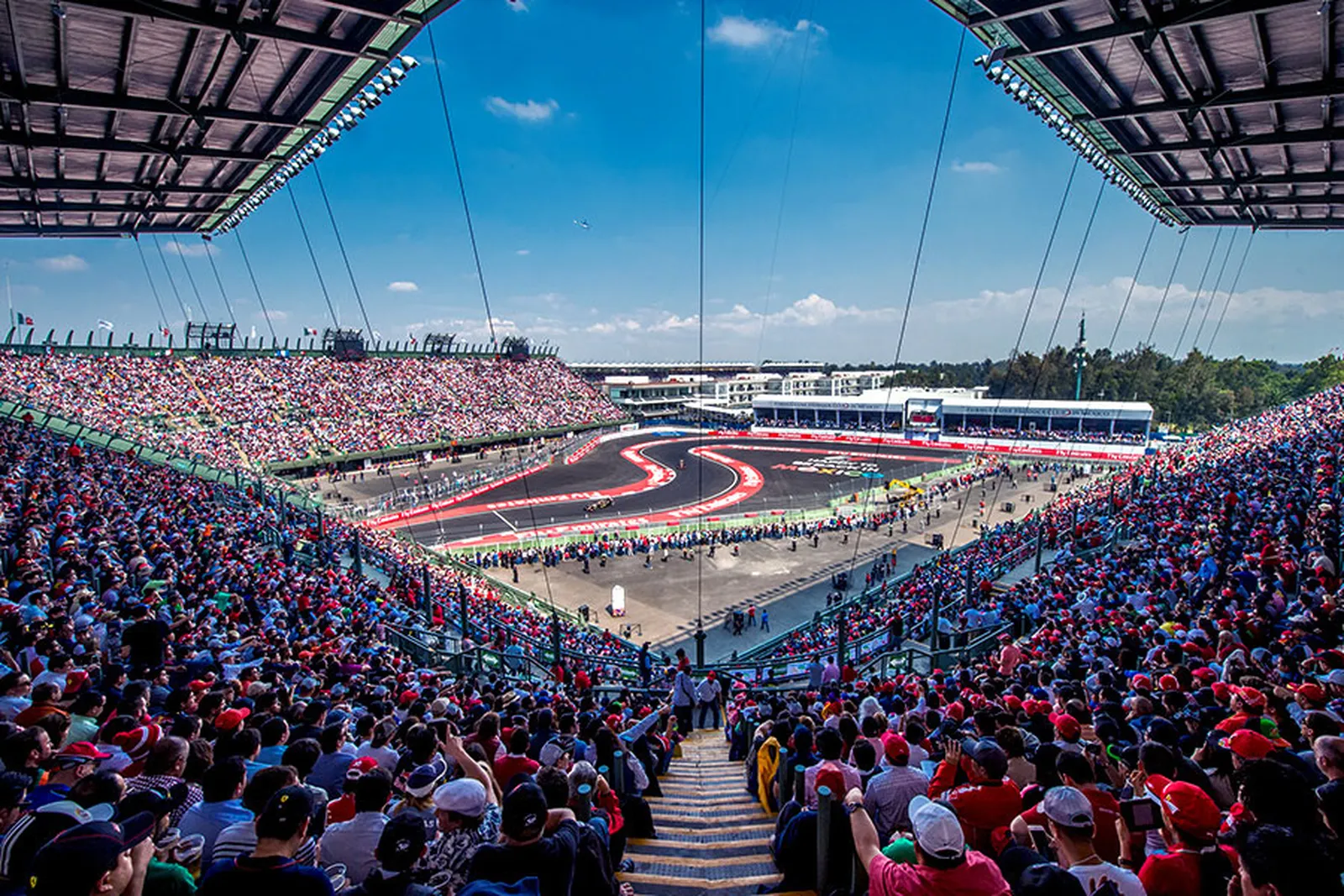 The crowd inside the Foro Sol stadium section, flags up.