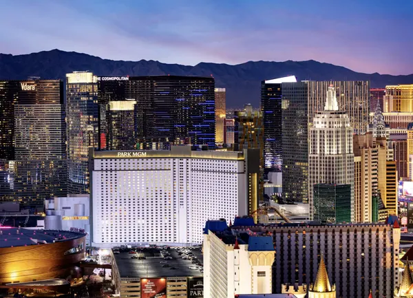 The Park MGM tower at dusk, mid-Strip, with the mountains behind Las Vegas.