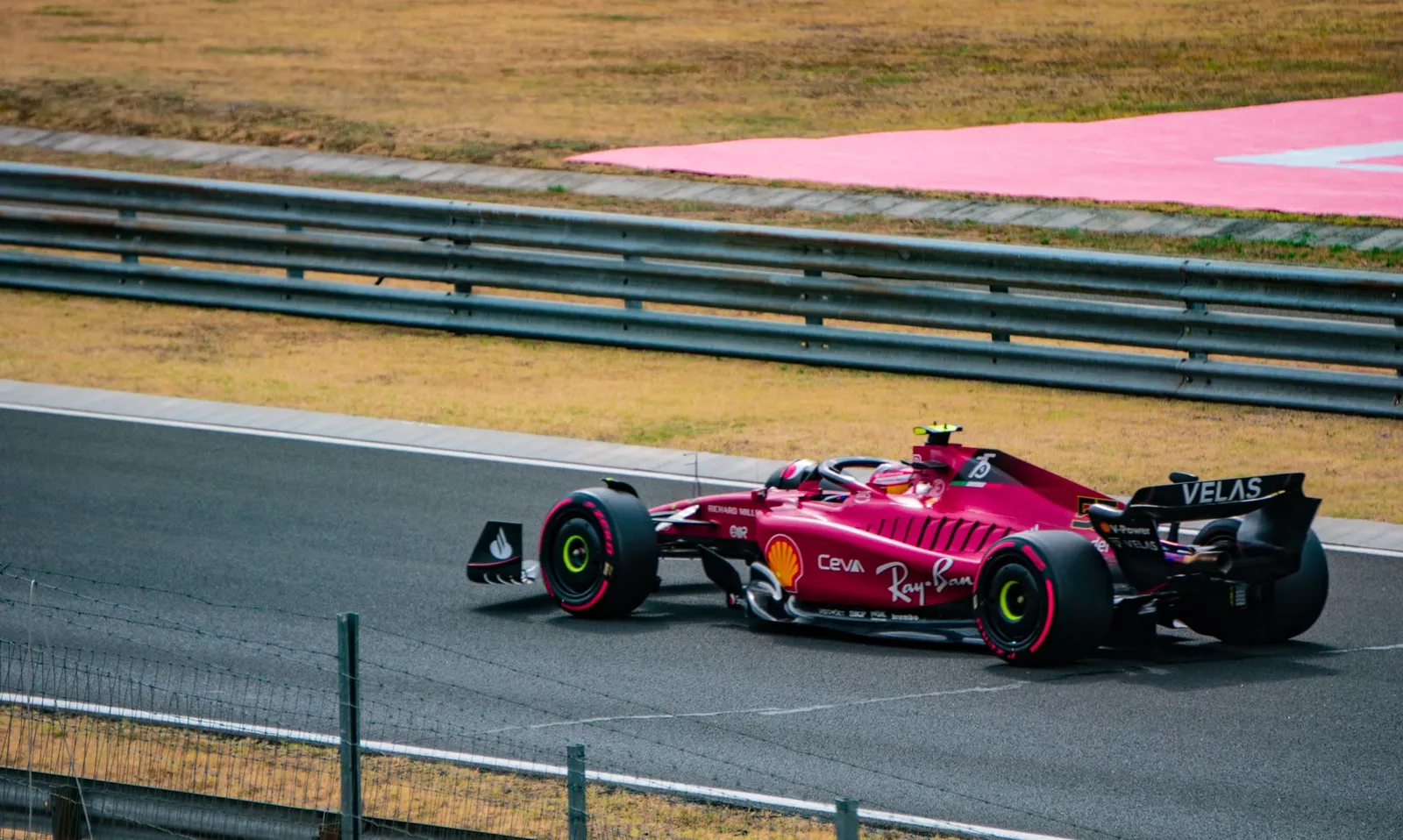 A Ferrari at speed through a fast corner.
