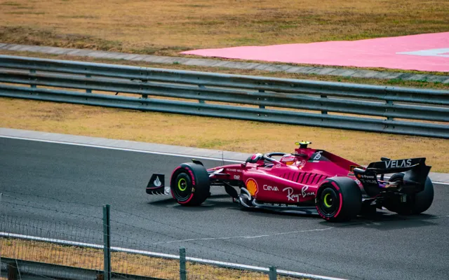 A Ferrari at speed through a fast corner.