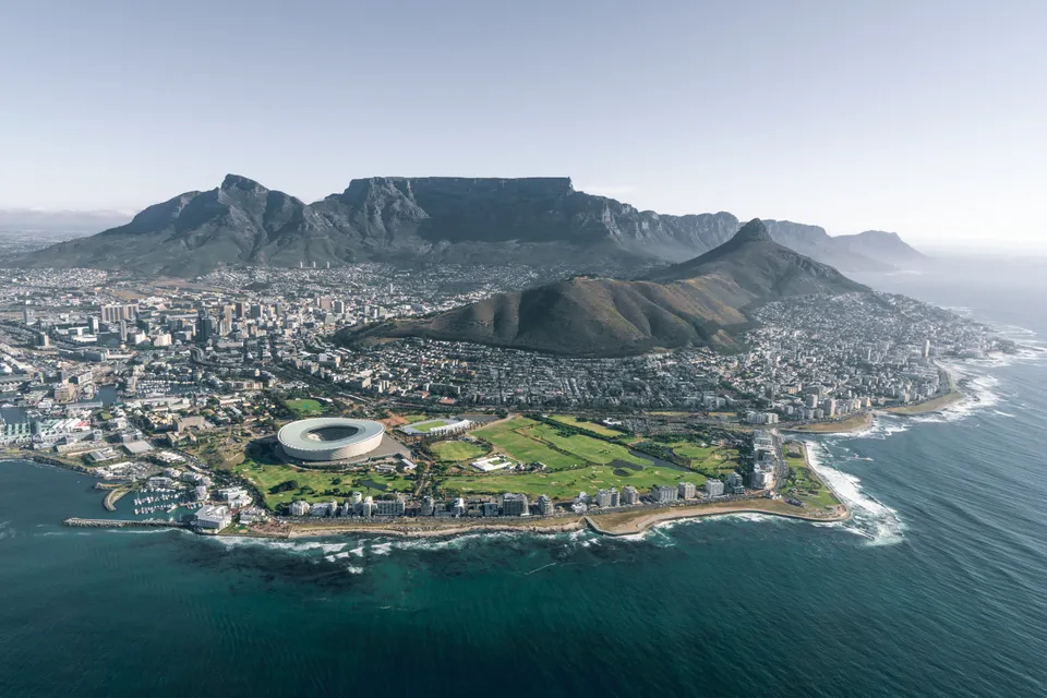 Cape Town from the air: Table Mountain behind the stadium and the sea.
