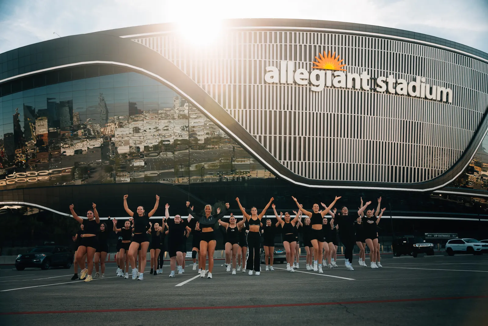 A visiting dance squad mid-routine in front of Allegiant Stadium, Las Vegas