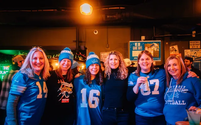 A group of fans in jerseys at the bar.