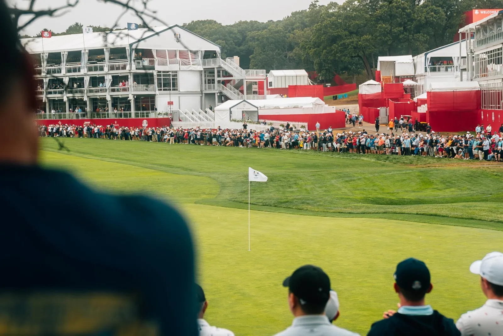 Crowds ring a tournament green.