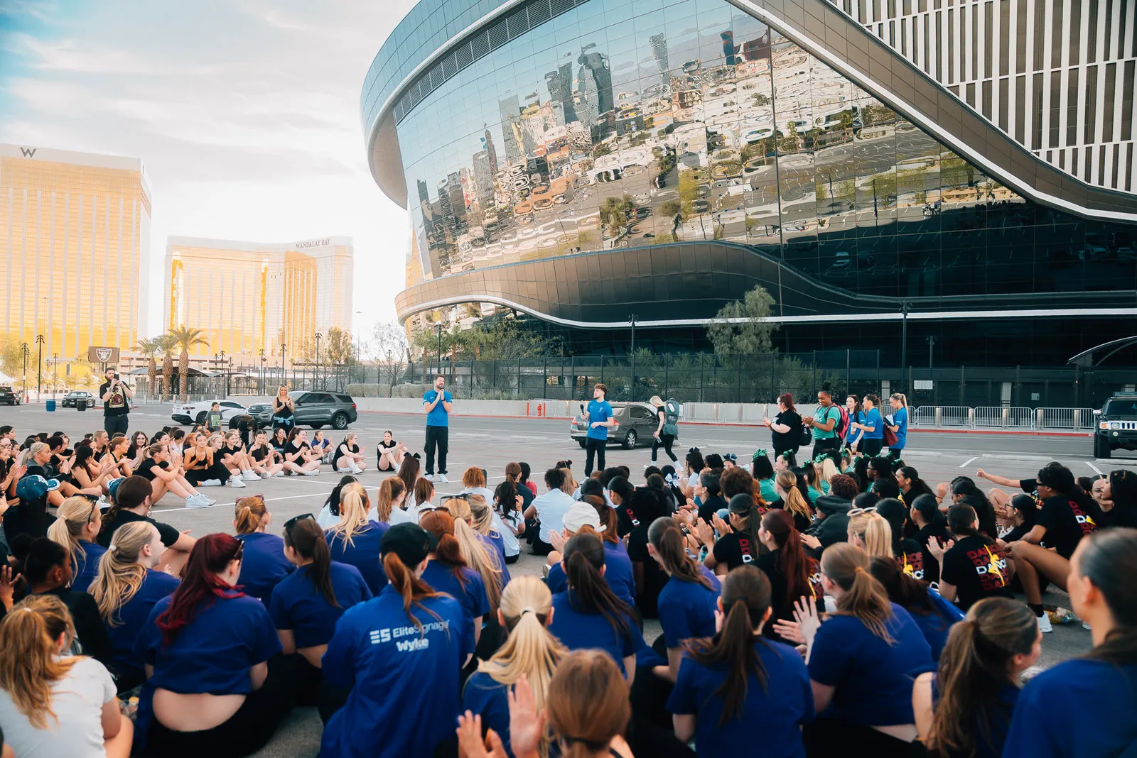 Hundreds of visiting performers gathered outside Allegiant Stadium at golden hour