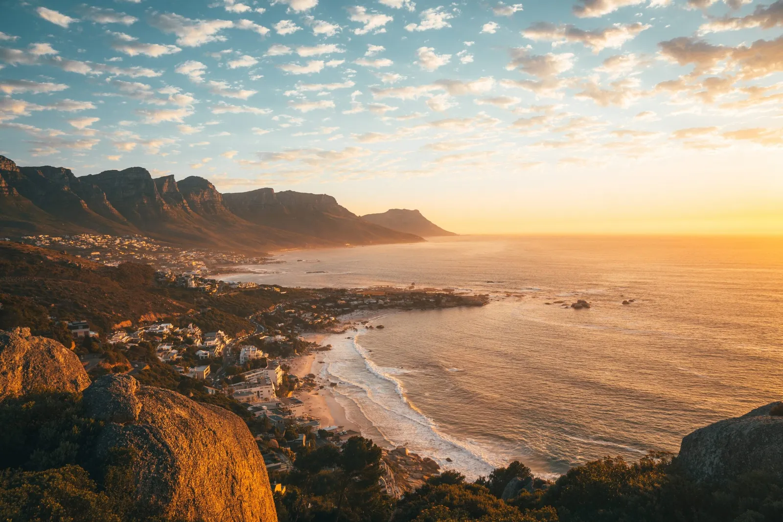 Camps Bay at sunset, the Atlantic turning gold.