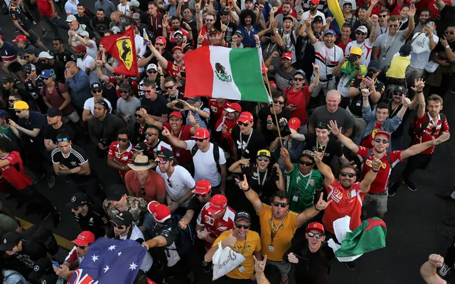 Fans packed against the fence on race day.