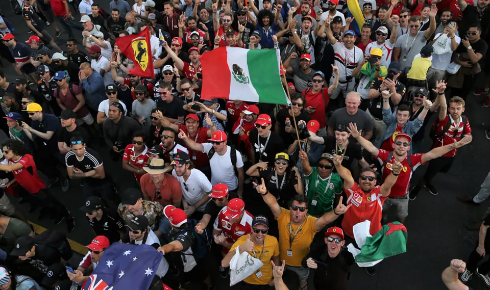 F1 fans packed against the fence on race day.