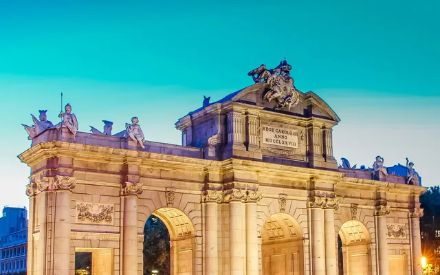 The Puerta de Alcalá lit at dusk.