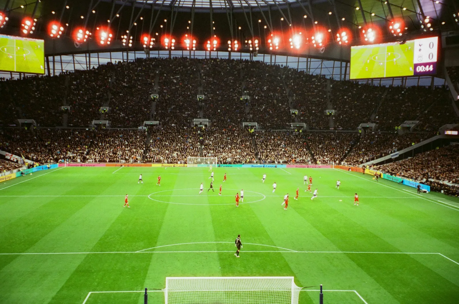 The bowl of the Tottenham Hotspur Stadium under lights.