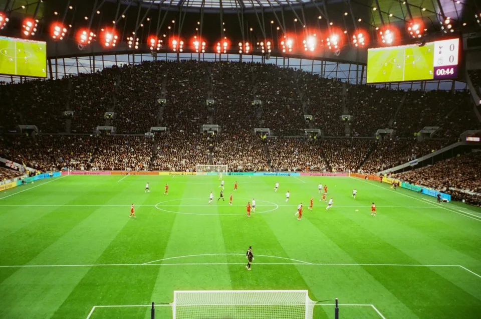The bowl of the Tottenham Hotspur Stadium under lights.