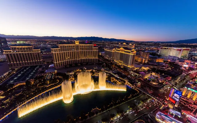The Bellagio fountains and the Strip at dusk.