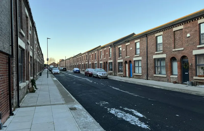 Row of brick terraced houses on a UK street