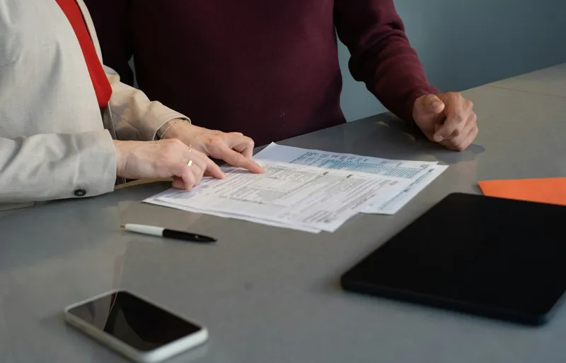 Two people going through paperwork together