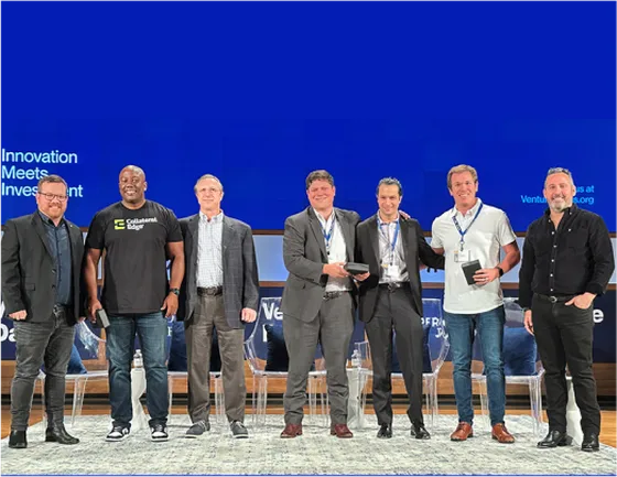 CollateralEdge team members receiving an award on stage at the Venture Dallas event