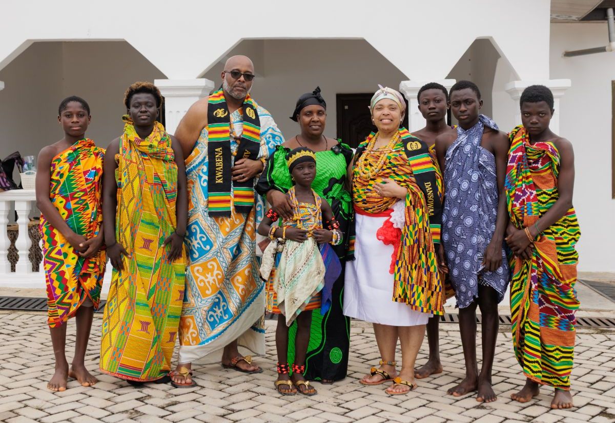 A group in full kente cloth after the naming ceremony at Cape Coast
