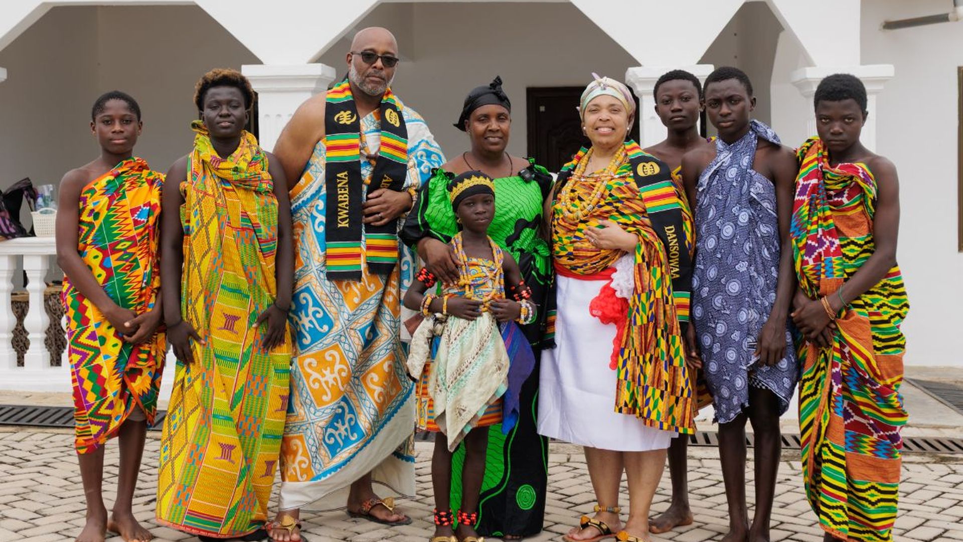 A group in full kente cloth after the naming ceremony at Cape Coast