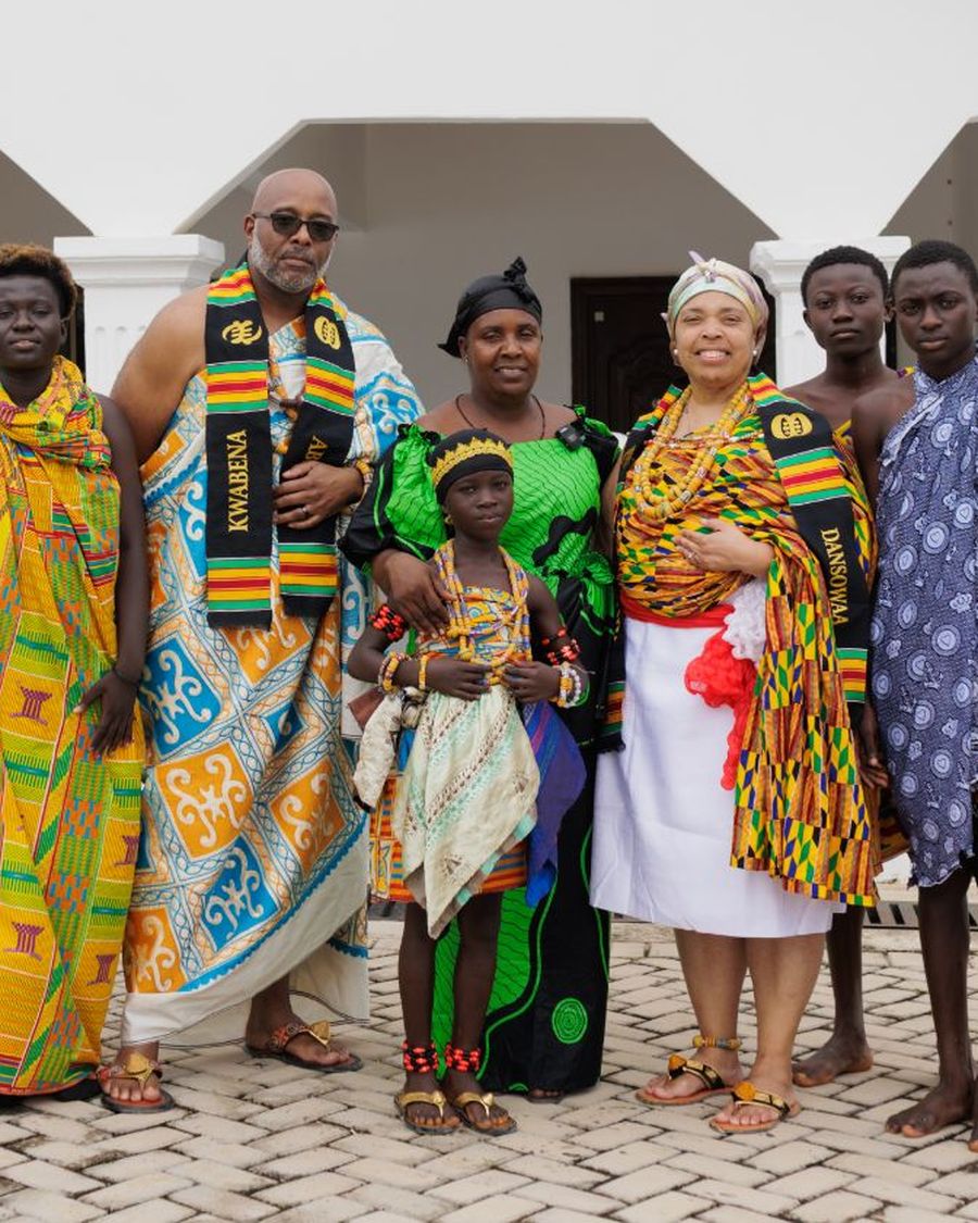 A group in full kente cloth after the naming ceremony at Cape Coast