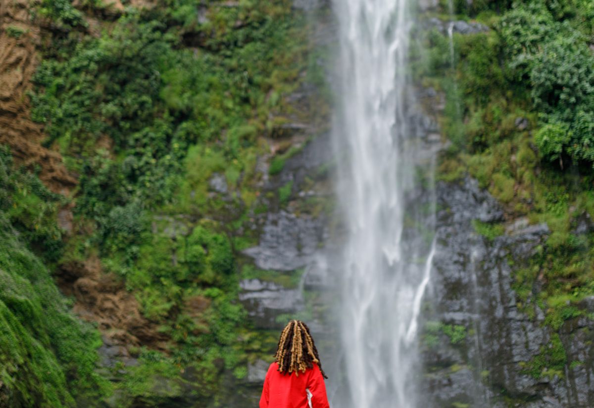 A traveler enjoying her time at the Wli waterfalls