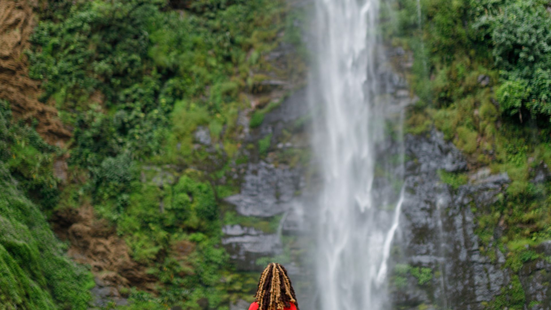 A traveler enjoying her time at the Wli waterfalls