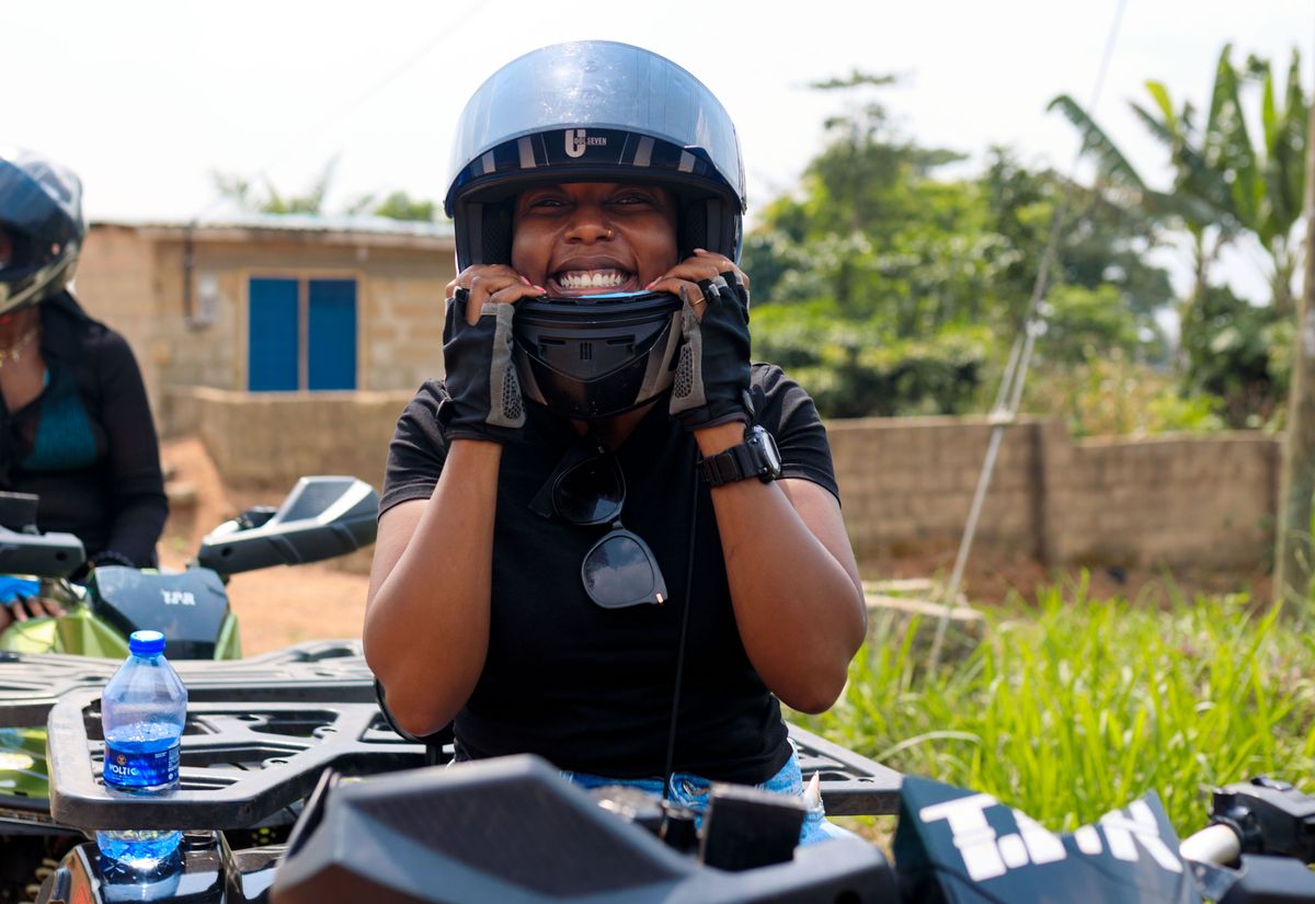 A guest in a helmet grinning on a quad bike before the ride out
