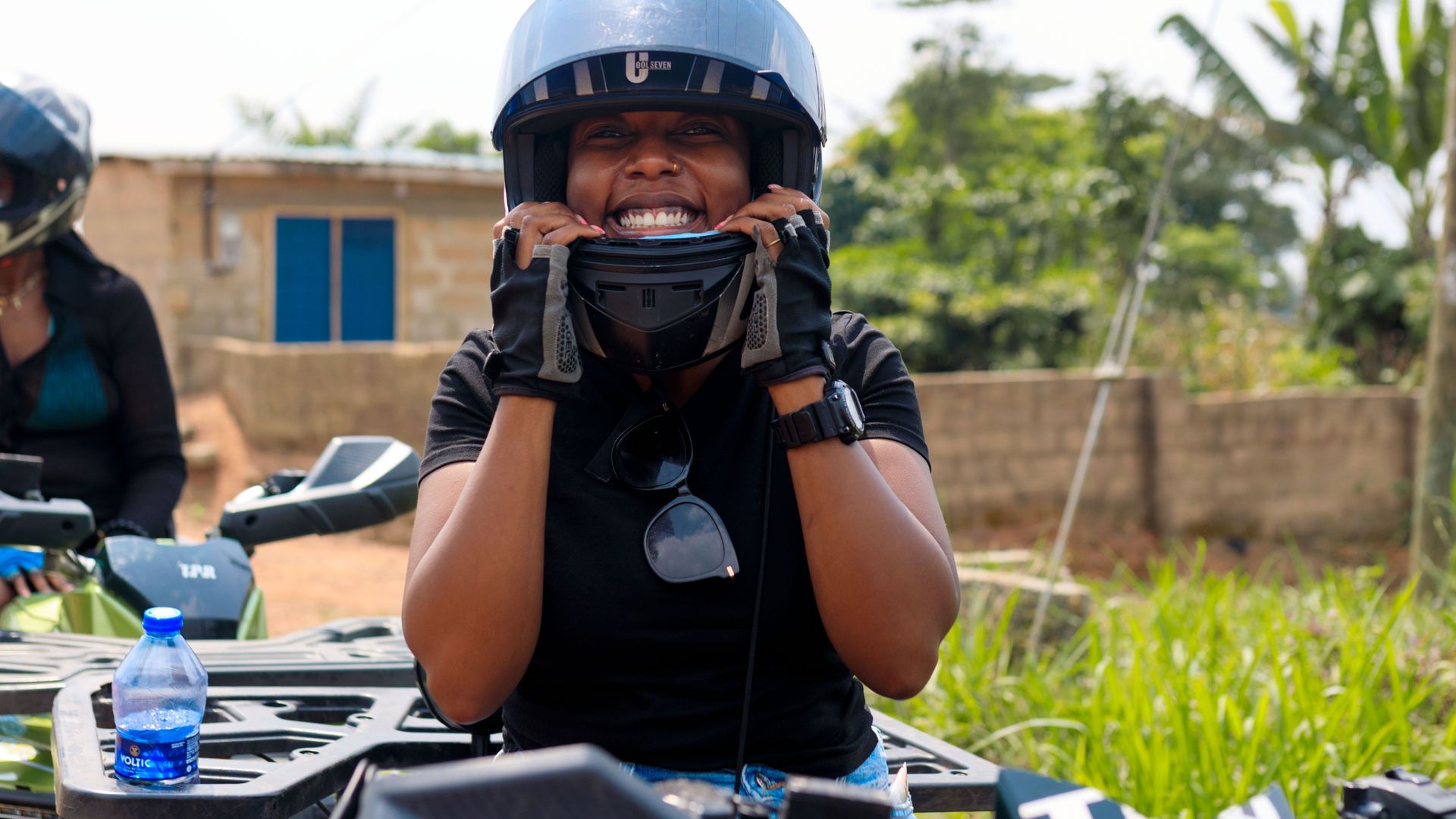 A guest in a helmet grinning on a quad bike before the ride out