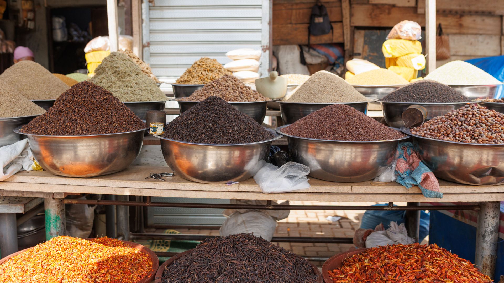 Bowls of spices and grains on a stall at Makola Market in Accra