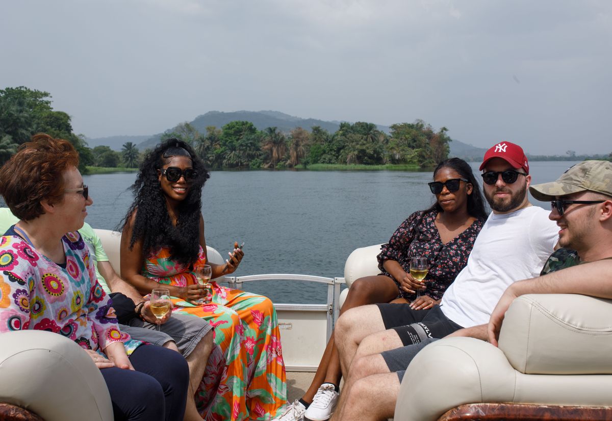 Guests sitting together on the boat cruise with the lake behind