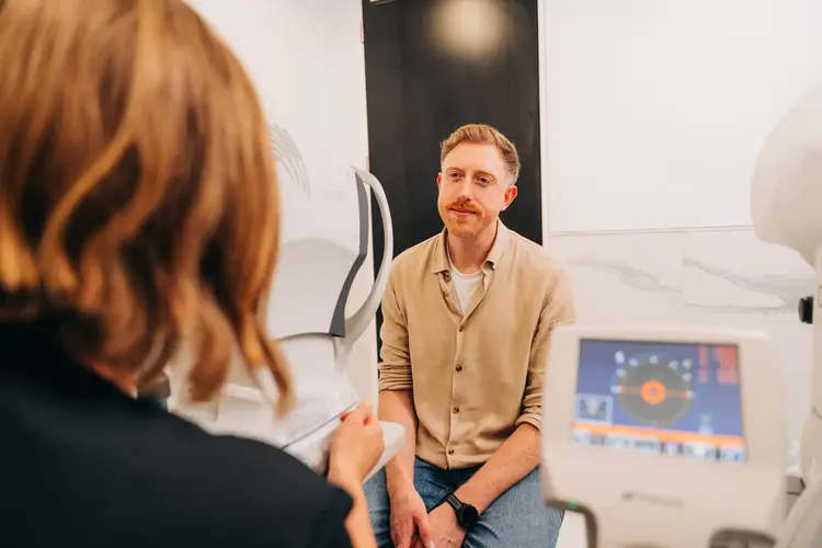 Man with a moustache during an eye consultation at Optilase