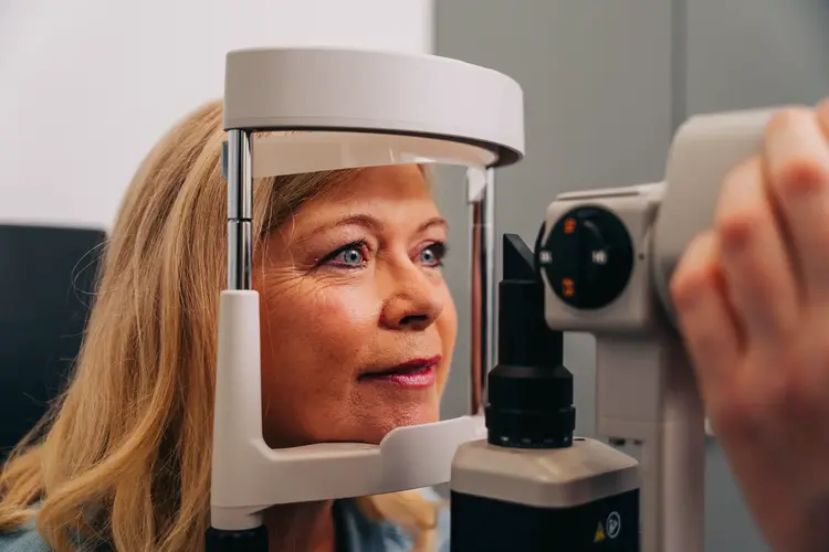 Woman having an eye exam with a slit lamp at Optilase Eye Clinic