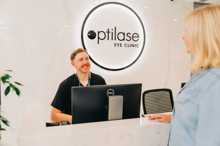 Optilase staff member greeting a patient at the front desk