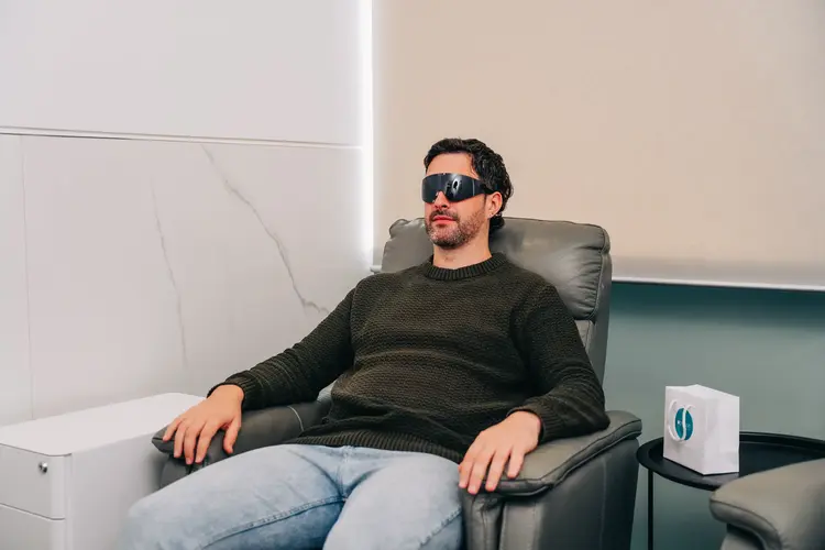 A man wearing protective glasses after his laser eye surgery at Optilase.
