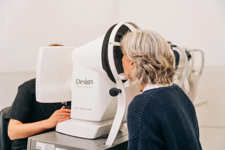 Older woman having an eye examination on an iDesign machine at Optilase