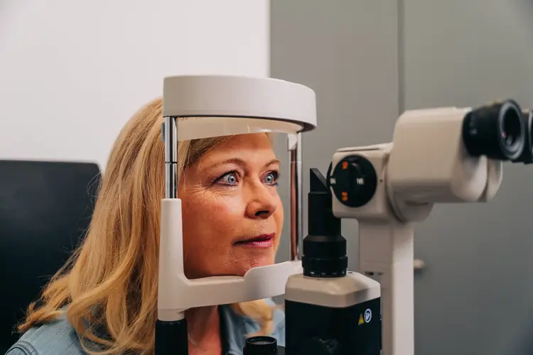 Woman having an eye examination with a slit lamp
