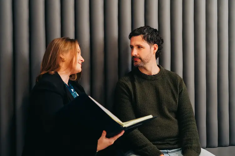 Optilase staff member going through eye exam results with a patient