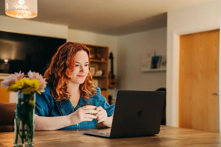 Woman working on a laptop after her lens replacement surgery