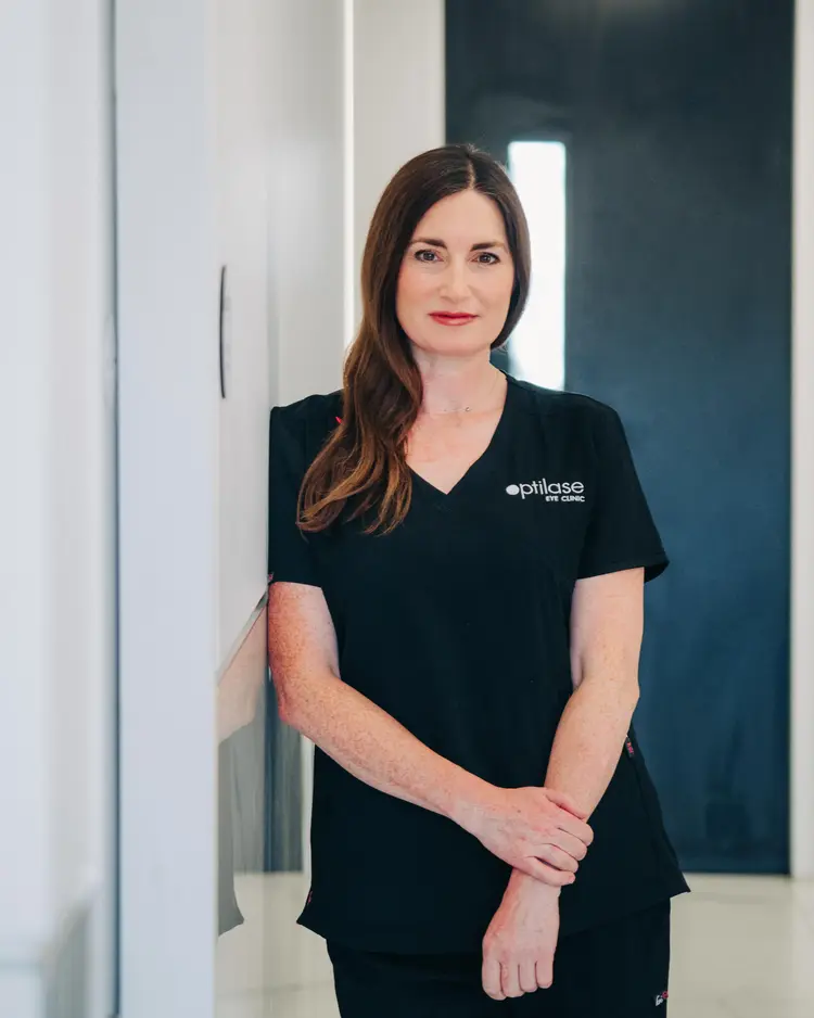 Optilase clinician in black scrubs standing in the clinic